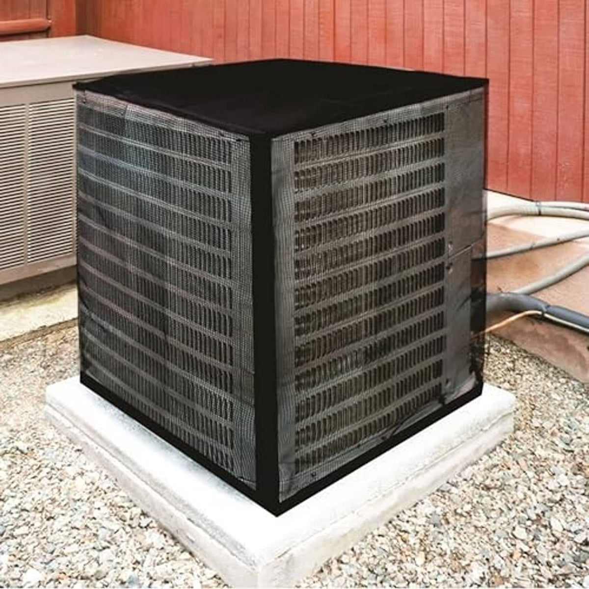 Outdoor A/C unit cover in black with mesh sides, fitted on a concrete base