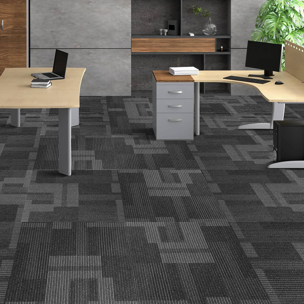 Mixed gray square carpet tiles covering an office floor under desks and chairs