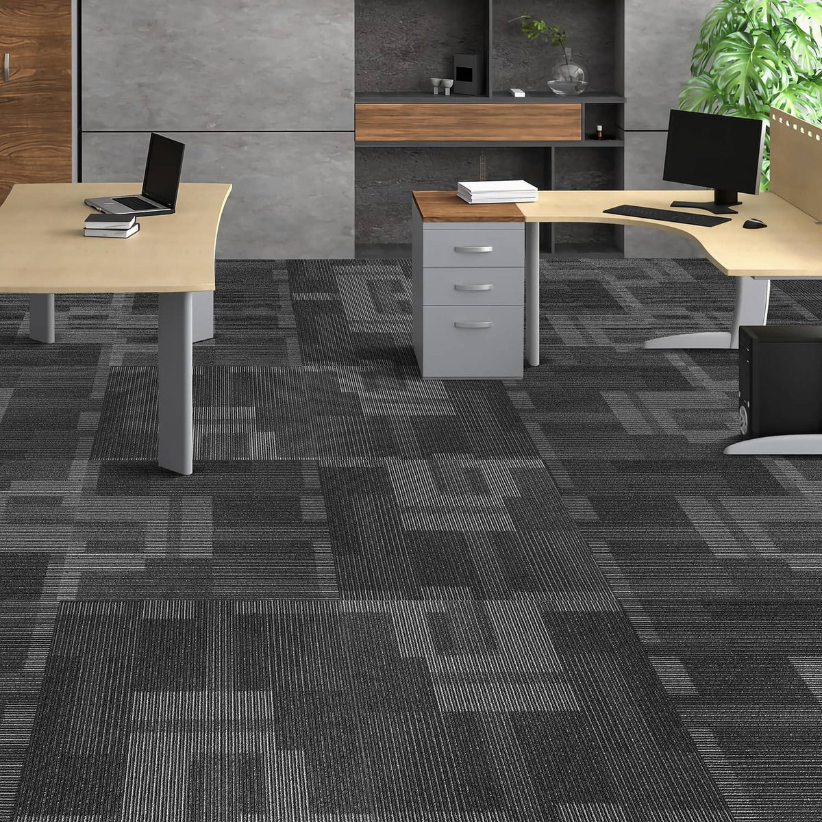 Mixed gray square carpet tiles covering an office floor under desks and chairs