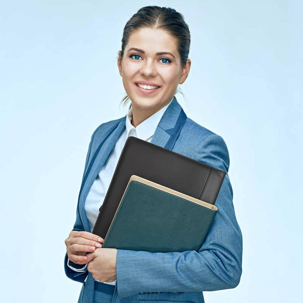 Black padfolio folder held by person, with teal inner cover panel visible