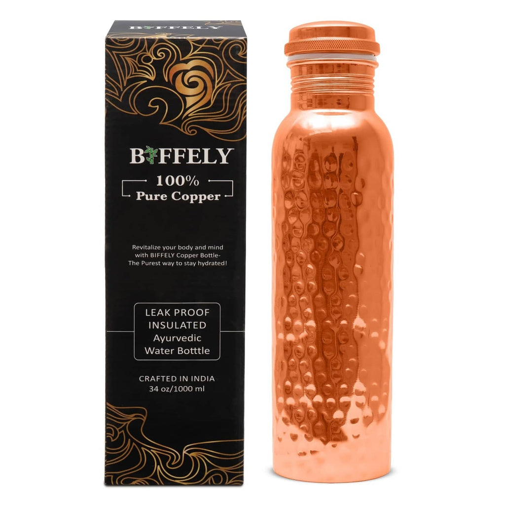 34 oz copper water bottle with hammered surface and screw-top cap.