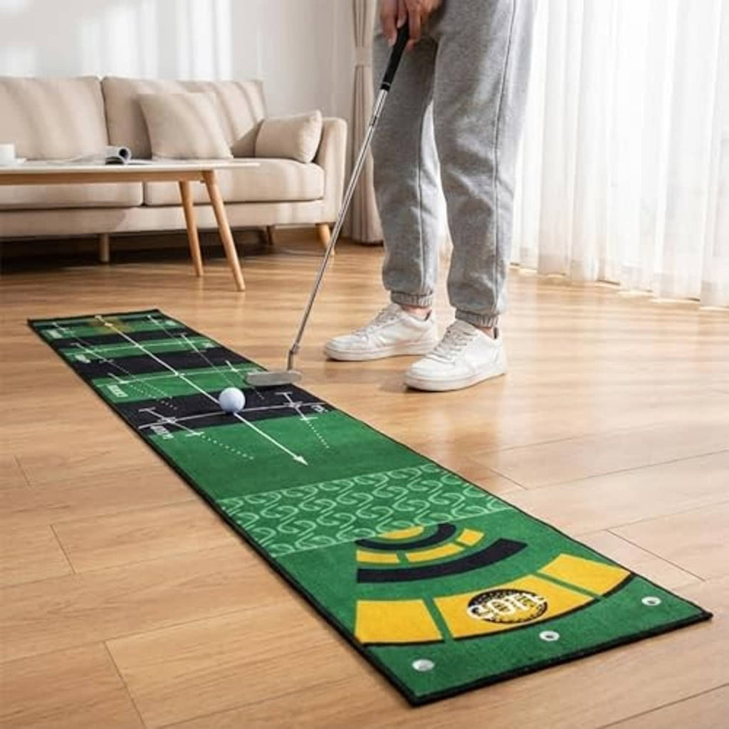 Green indoor golf putting mat on hardwood floor with white practice ball