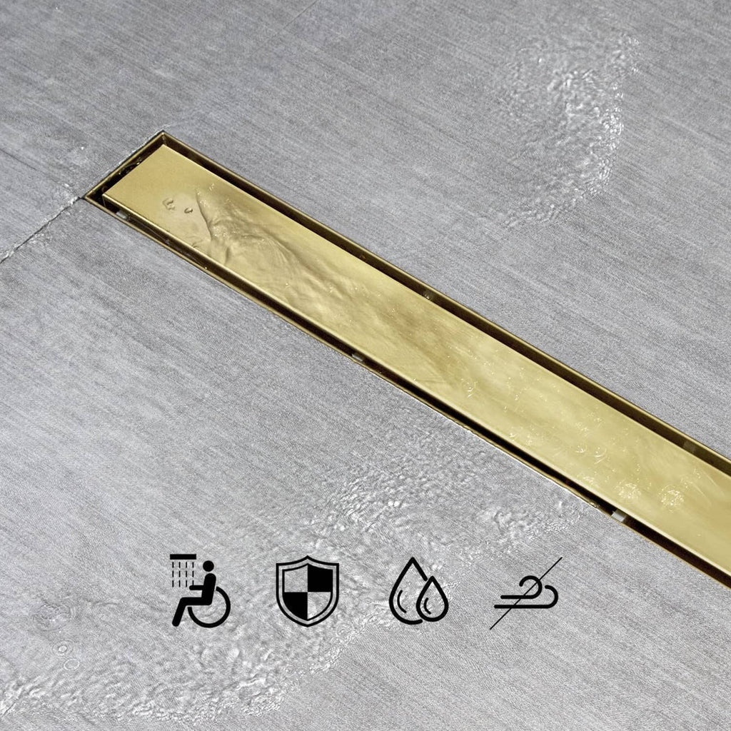 Gold linear shower drain tile insert grate viewed from above on tile