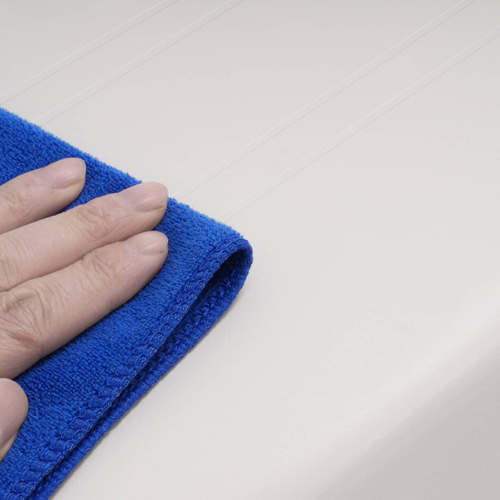 White seat back cushion with smooth top surface, hand pressing with cloth