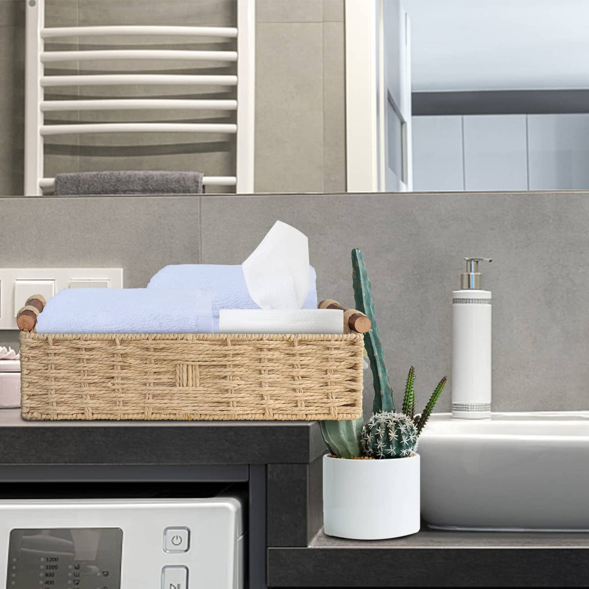 Beige woven paper rope storage basket with rope handles, open-top on dark countertop.
