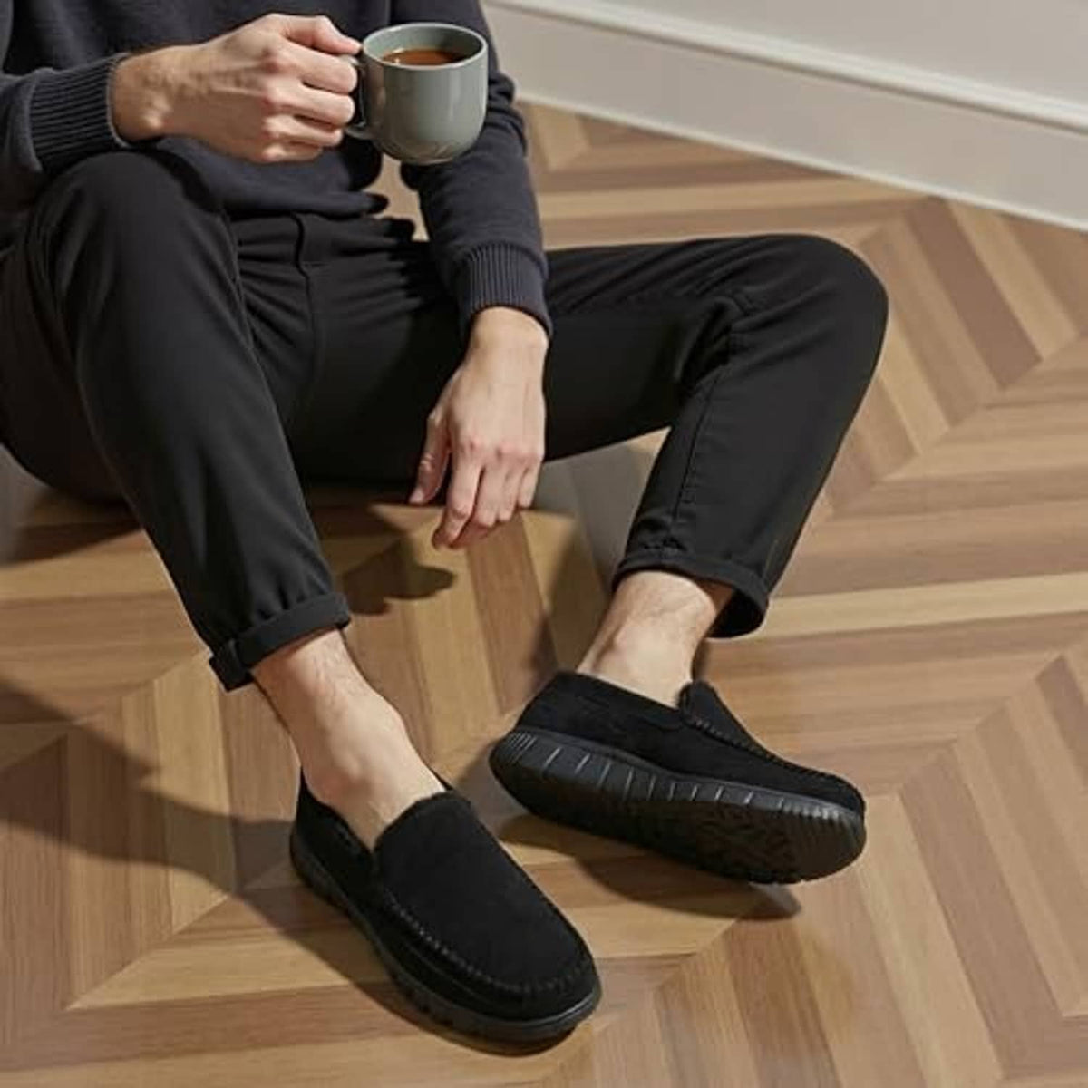 Men's black faux-fur slip-on loafers worn with dark pants