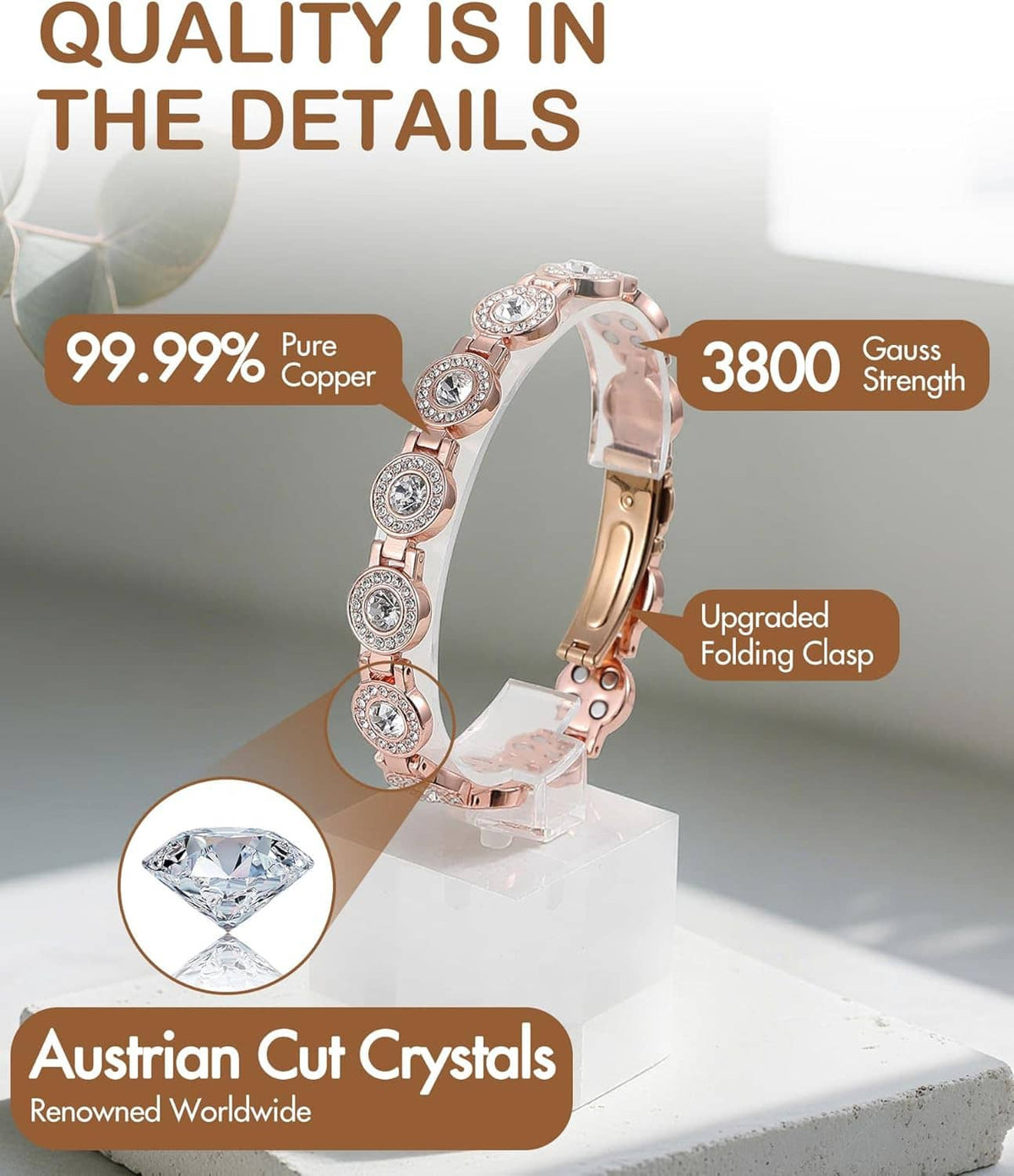 Rose gold copper bracelet with rhinestone oval links on a display stand
