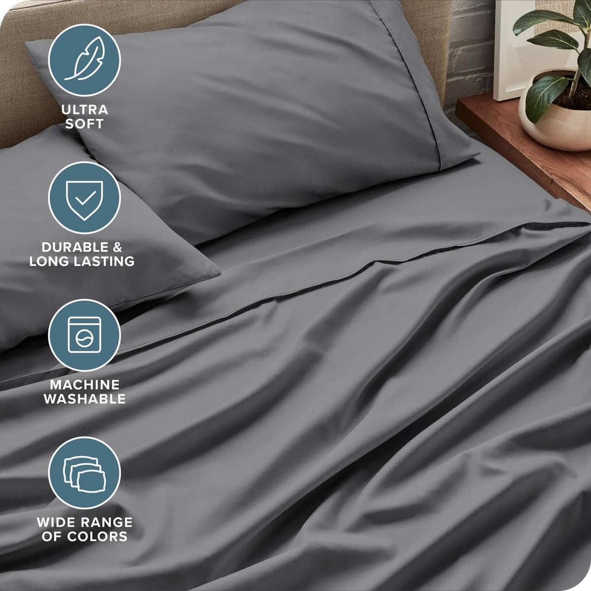 Grey sheet and pillowcases with smooth fabric folds, close-up on bedding