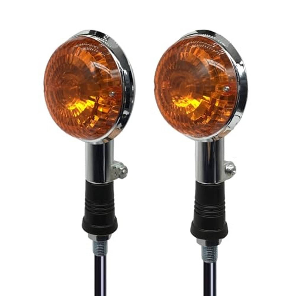 Two amber motorcycle turn signal lights with chrome rims and black stem mounts