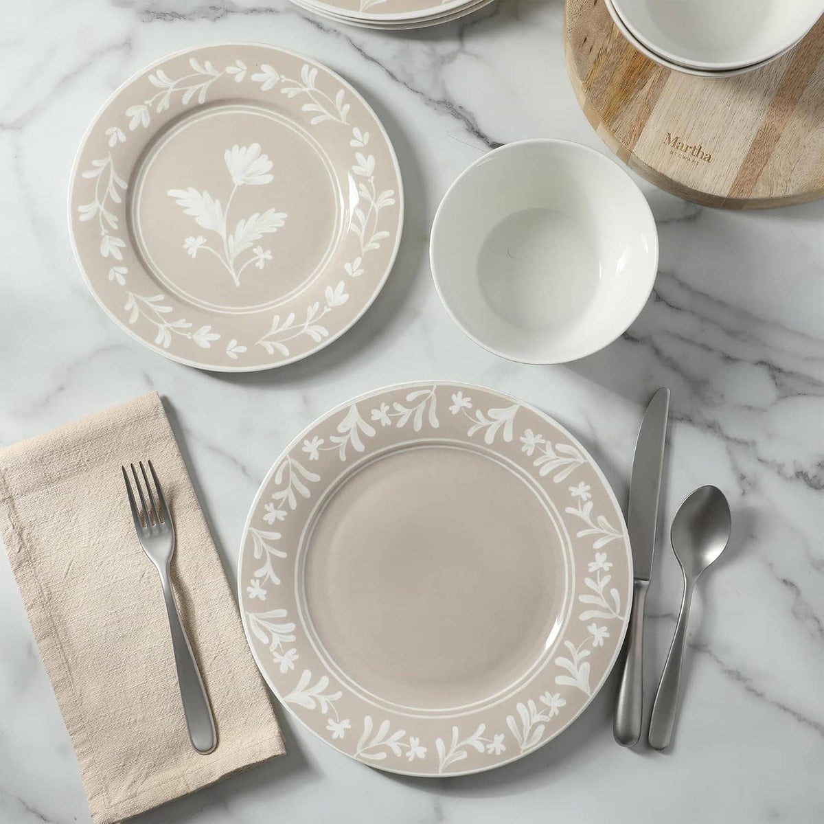 Taupe porcelain plates and bowls with white floral wreath and leaf details
