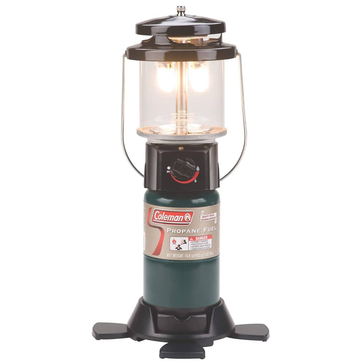 Coleman propane lantern with clear glass chimney, dark base, and side handles