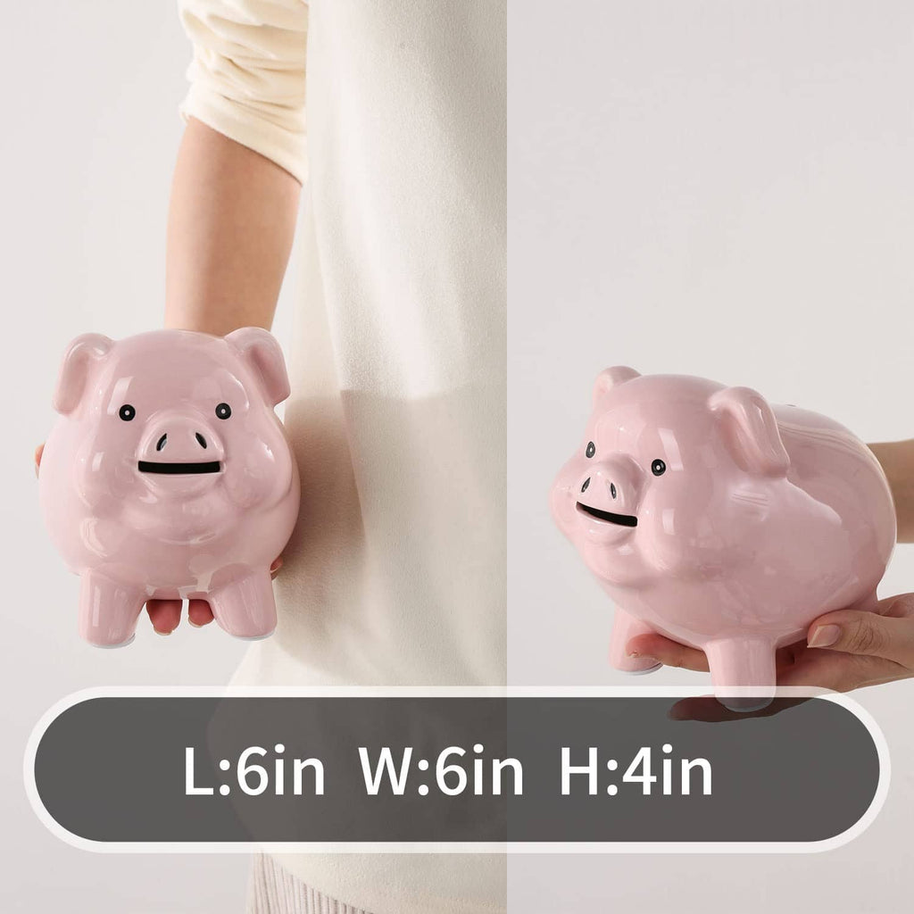 Pink ceramic piggy bank held in hand, smiling face and short legs