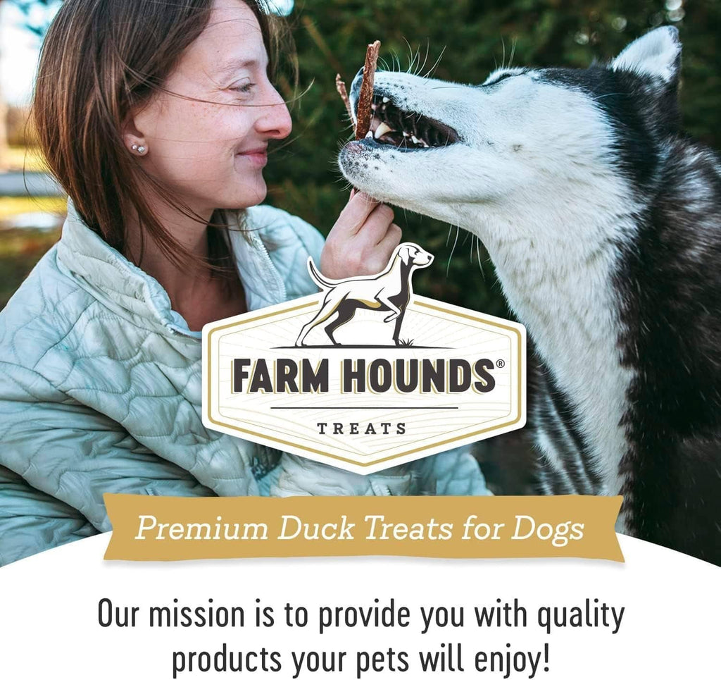 Dog treats package with Farm Hounds logo held by a smiling person with a dog