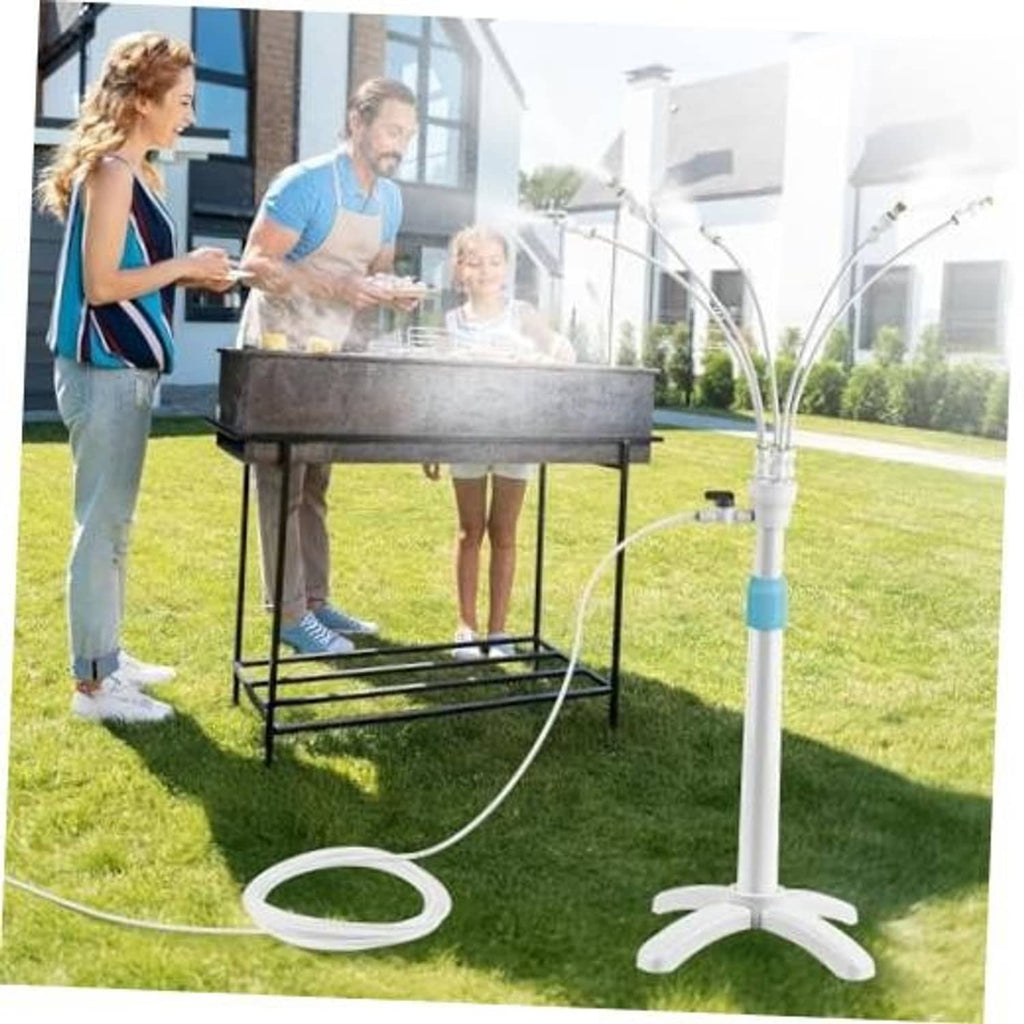 Standing outdoor misting system with white pole, blue band, and circular hose loop on grass