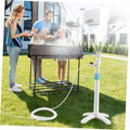 Standing outdoor misting system with white pole, blue band, and circular hose loop on grass