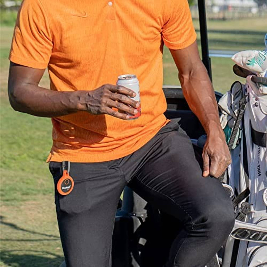 Orange silicone protective key fob case clipped on golfer’s shorts
