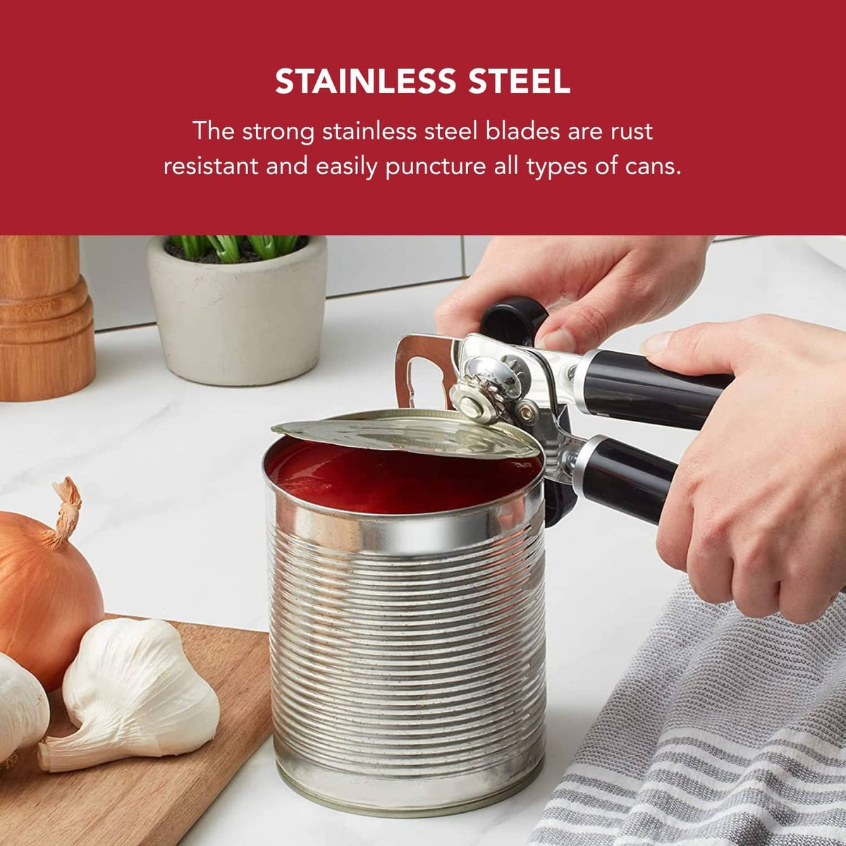 Black can opener with stainless steel blade gripping an opened can