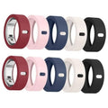 Silicone ring cover set in maroon, pink, navy, white, and black for smart ring charging.