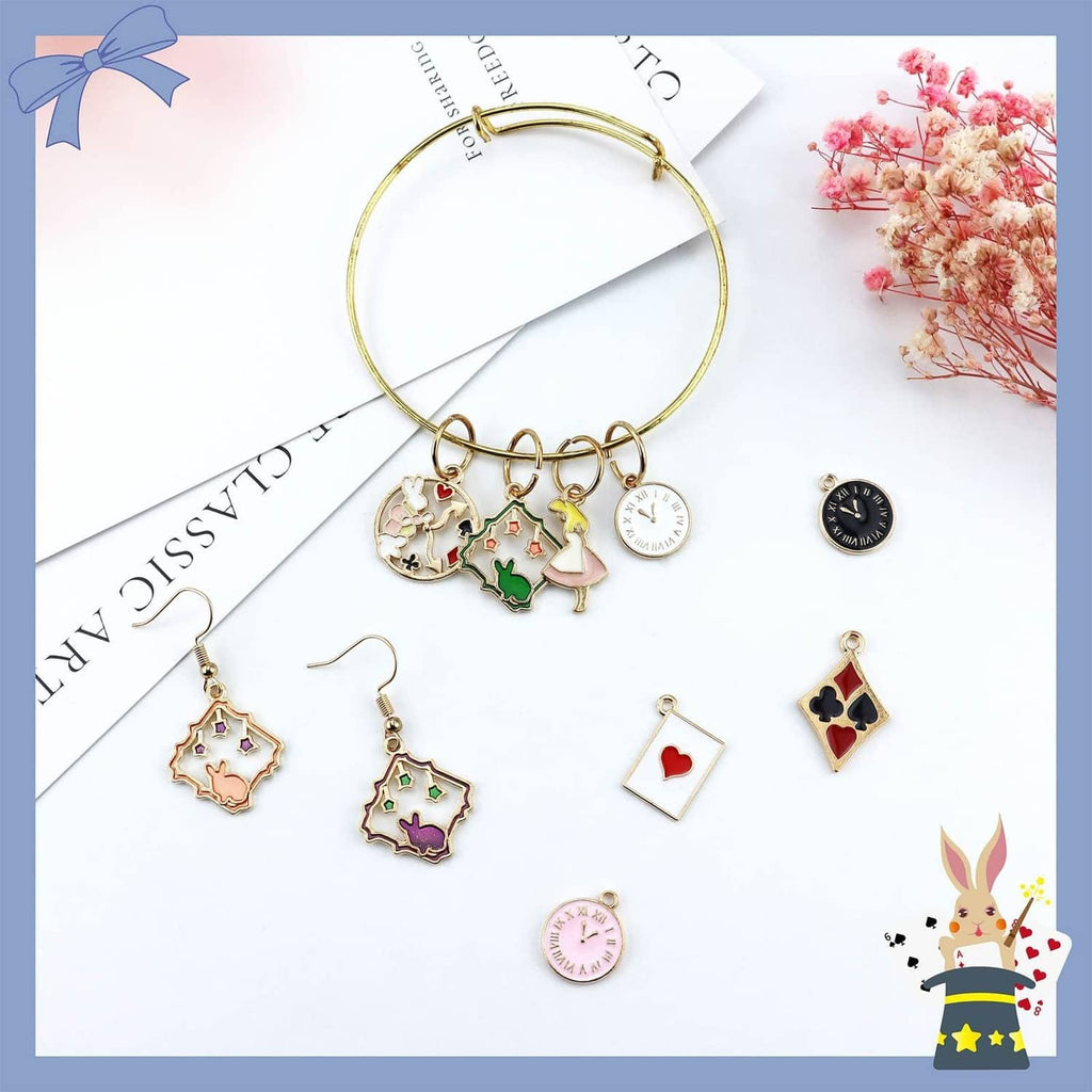 Gold bracelet cuff with attached gold-plated enamel charm pendants and heart playing-card charm.