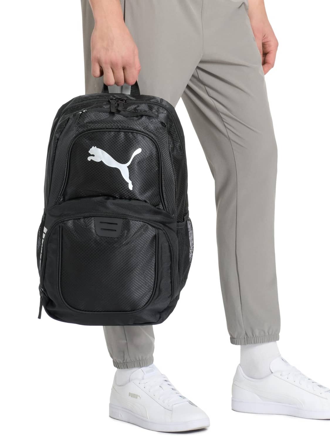 Puma Contender backpack carried by model, black front pocket with Puma logo