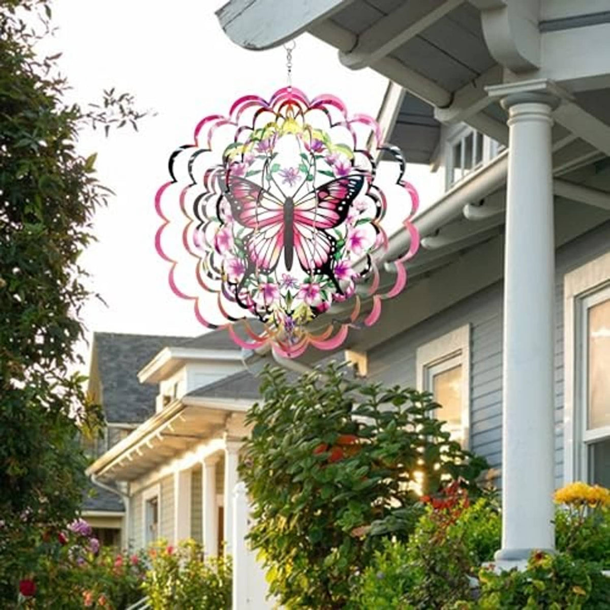 Hanging butterfly wind spinner with pink, purple, and green accents, layered circular design.