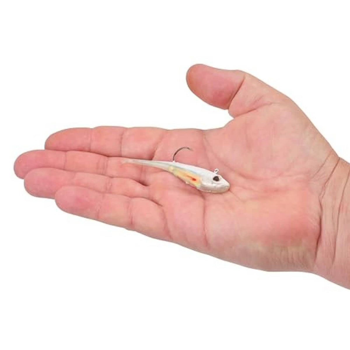 White shad-shaped soft plastic fishing bait on hook shown in open hand