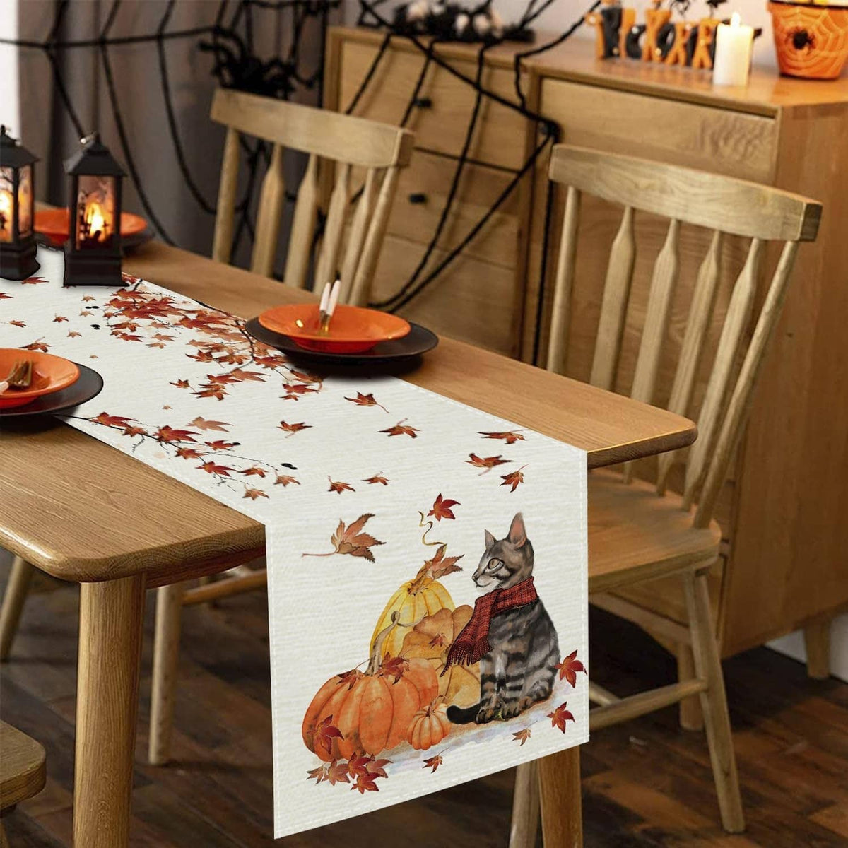 White fall table runner with cat and pumpkins print, scattered maple leaves