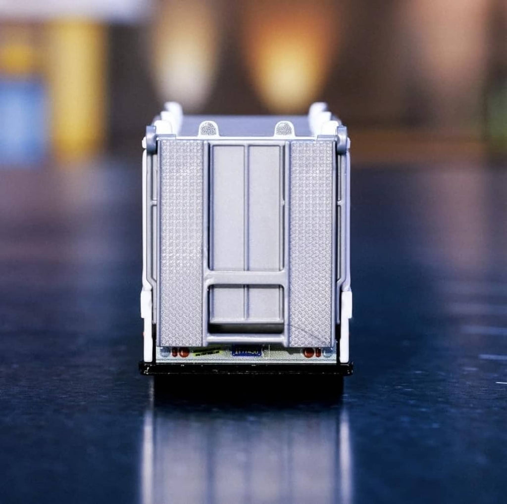 1:64 die-cast transport box vehicle, front view with textured panels