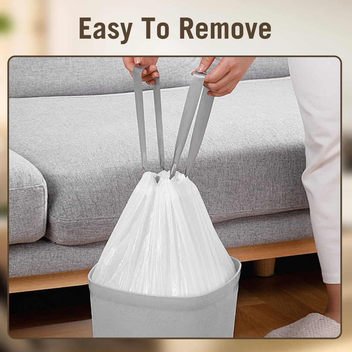 White drawstring trash bag being lifted off a trash can for easy removal