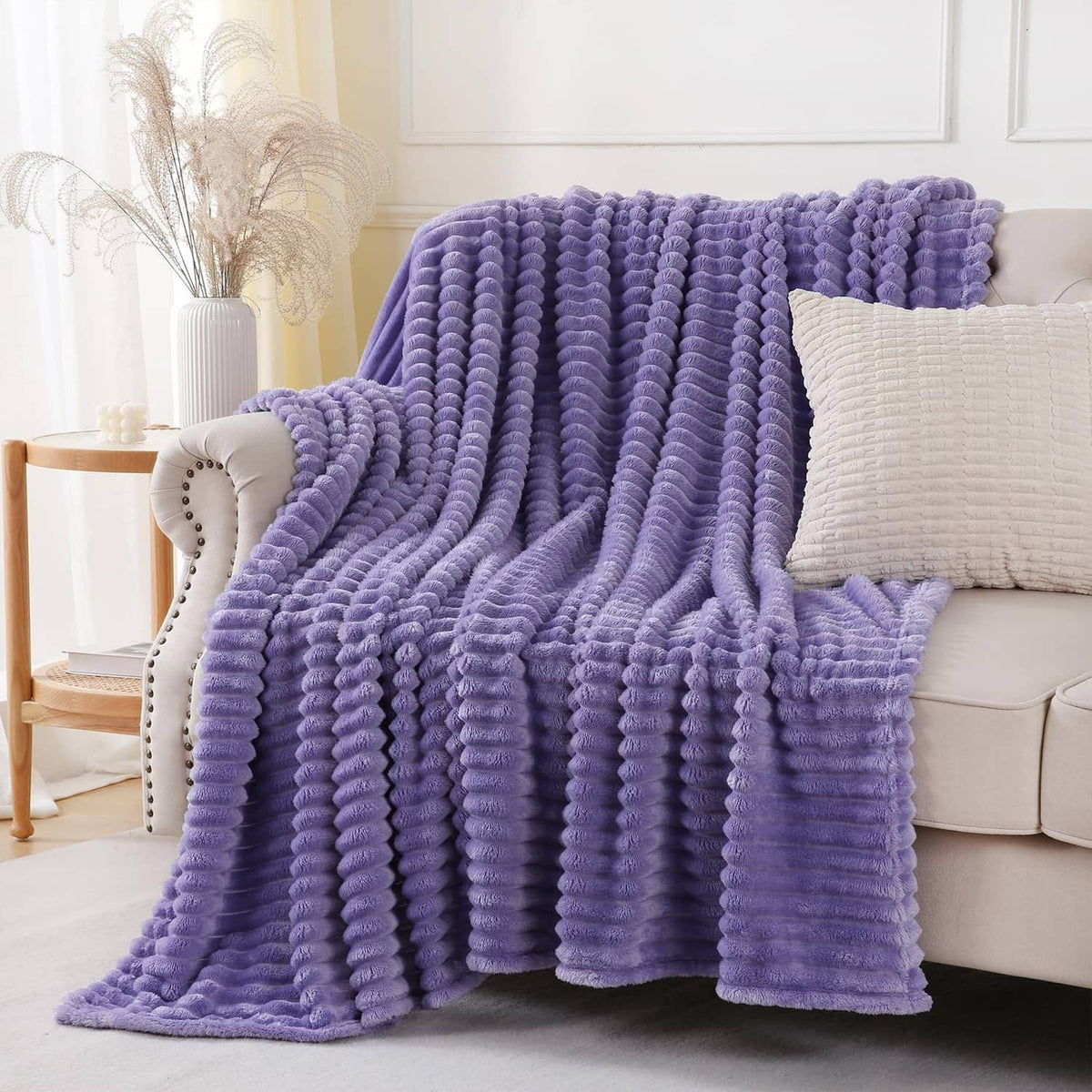 Lavender plush throw blanket with thick ribbed loops, covering sofa seat and back