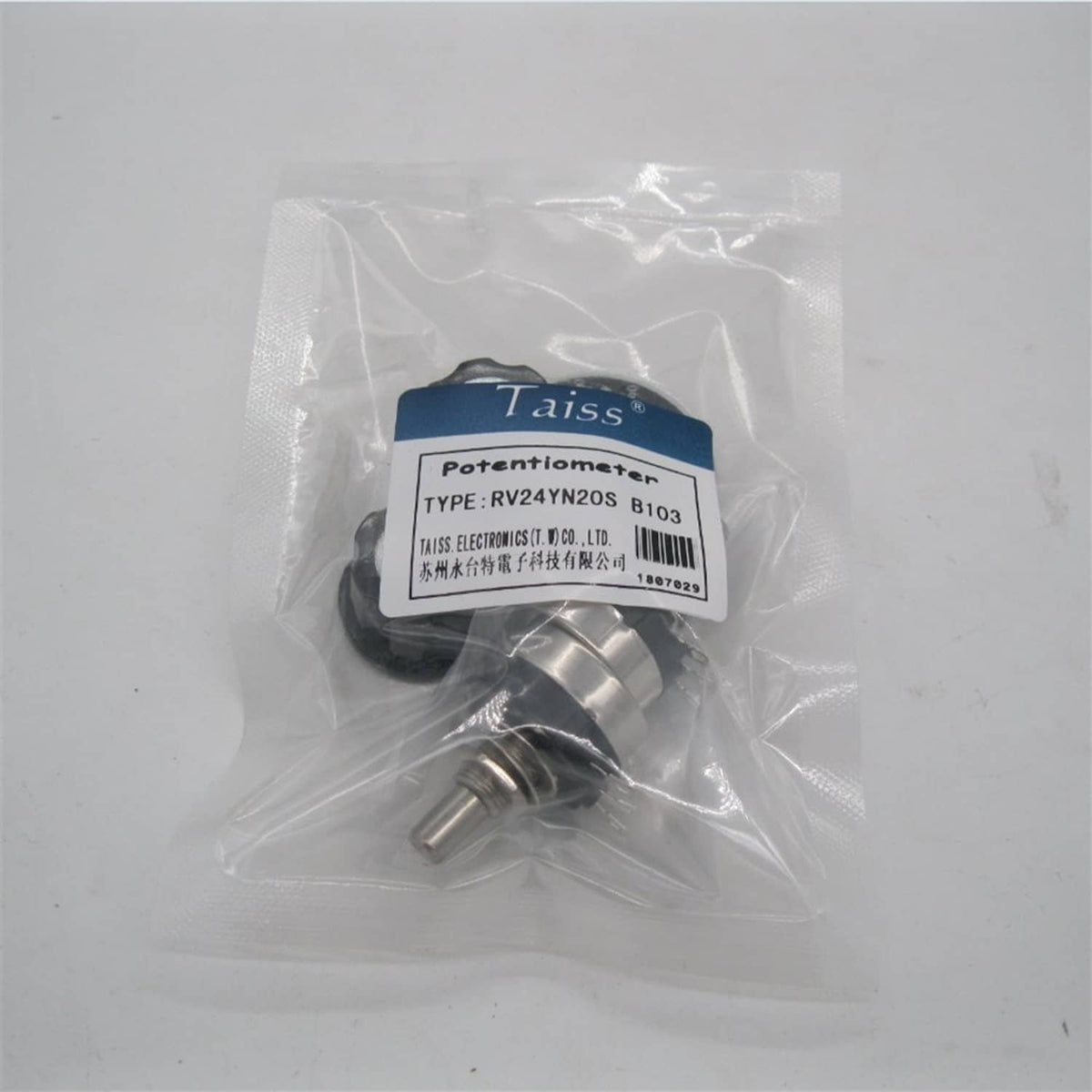 Sealed plastic bag containing a rotary potentiometer with metal shaft and base
