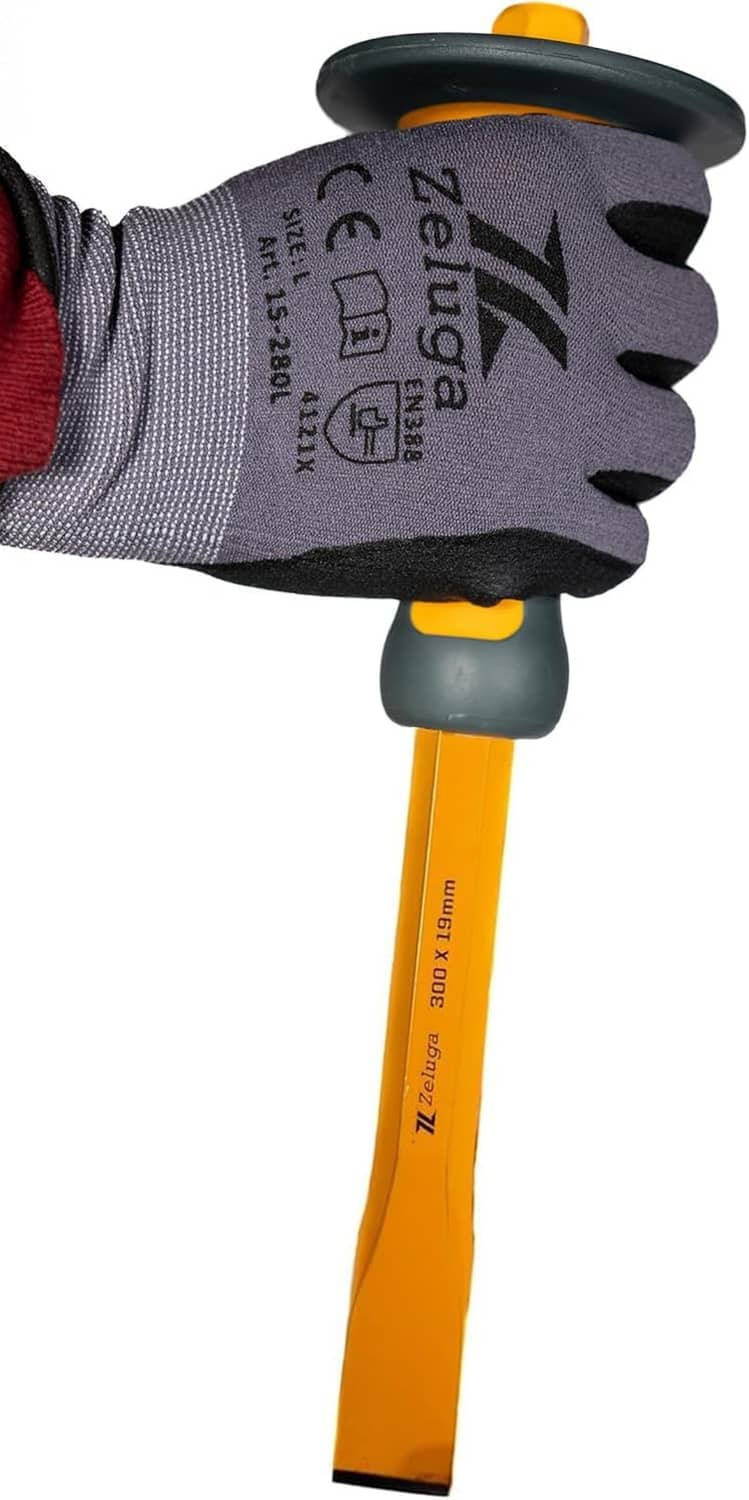 Hex flat masonry chisel in gloved hand, yellow handle with black grip