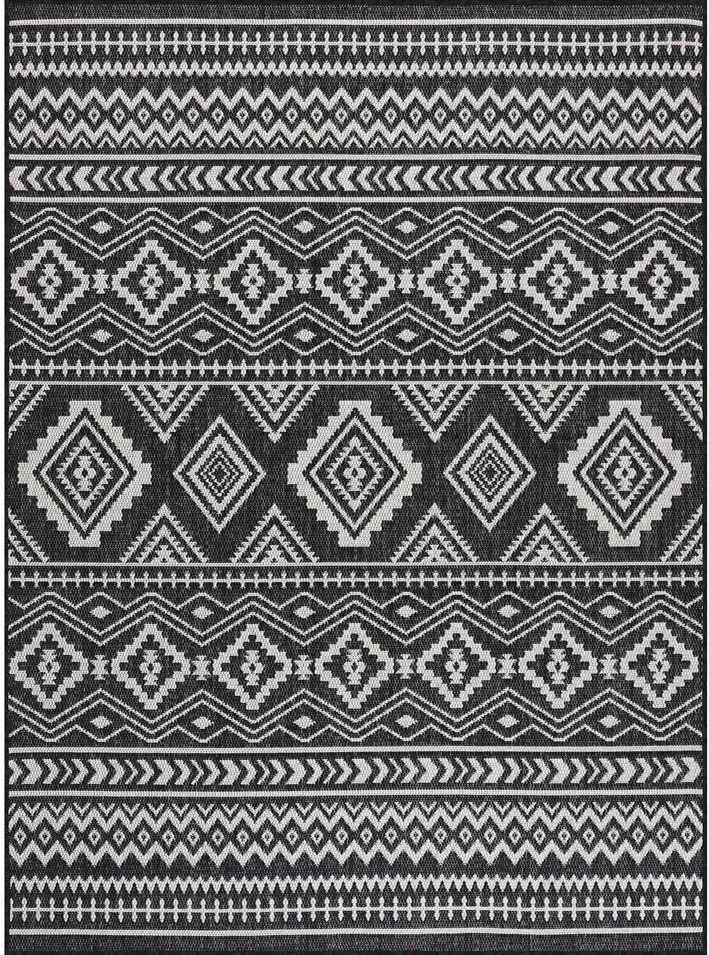 Black-and-white geometric rug showing layered diamond and border stripe design
