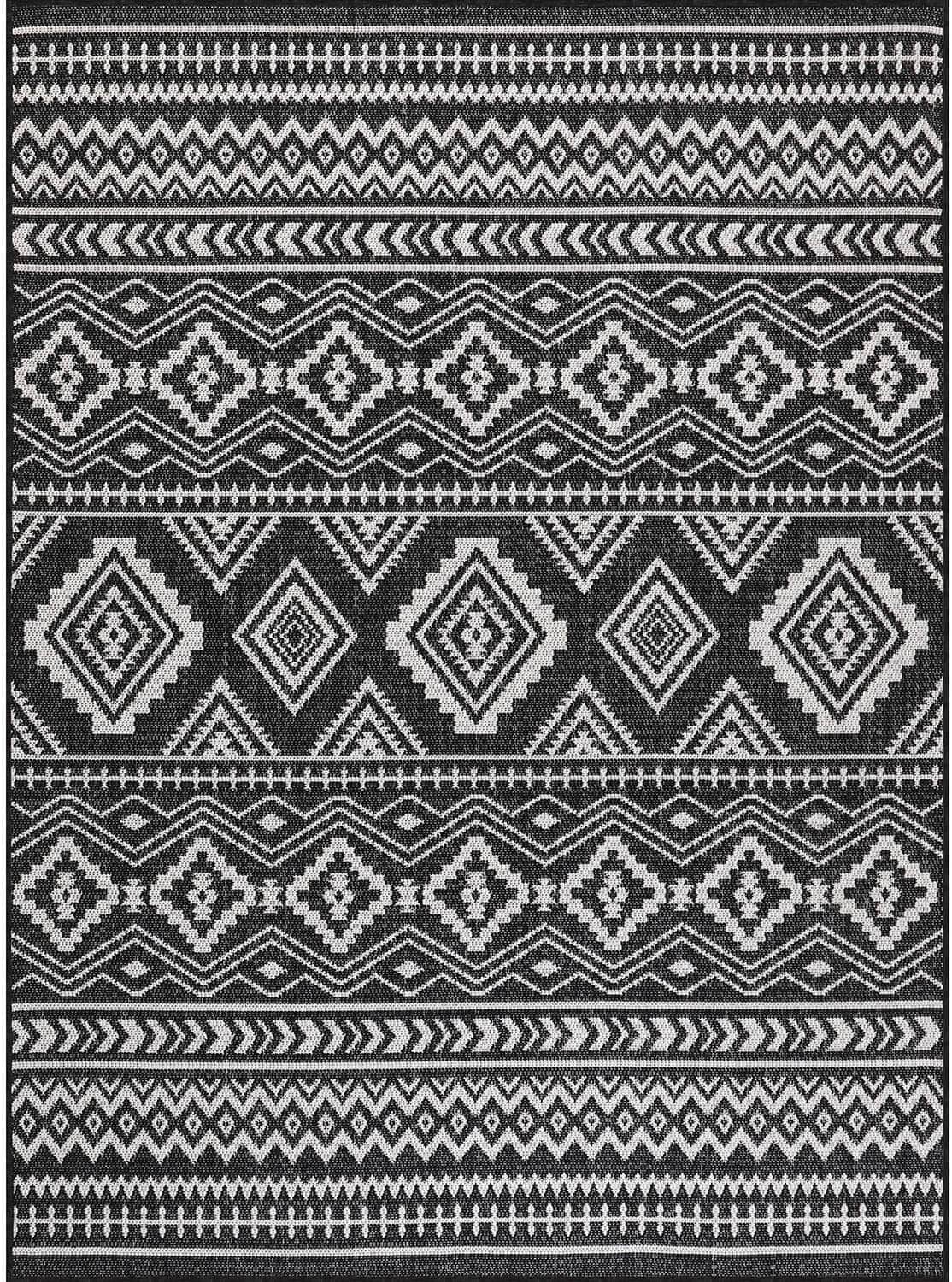 Black-and-white geometric rug showing layered diamond and border stripe design