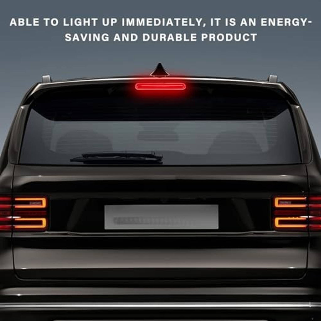 Installed red third brake light on a car rear hatch, centered and illuminated