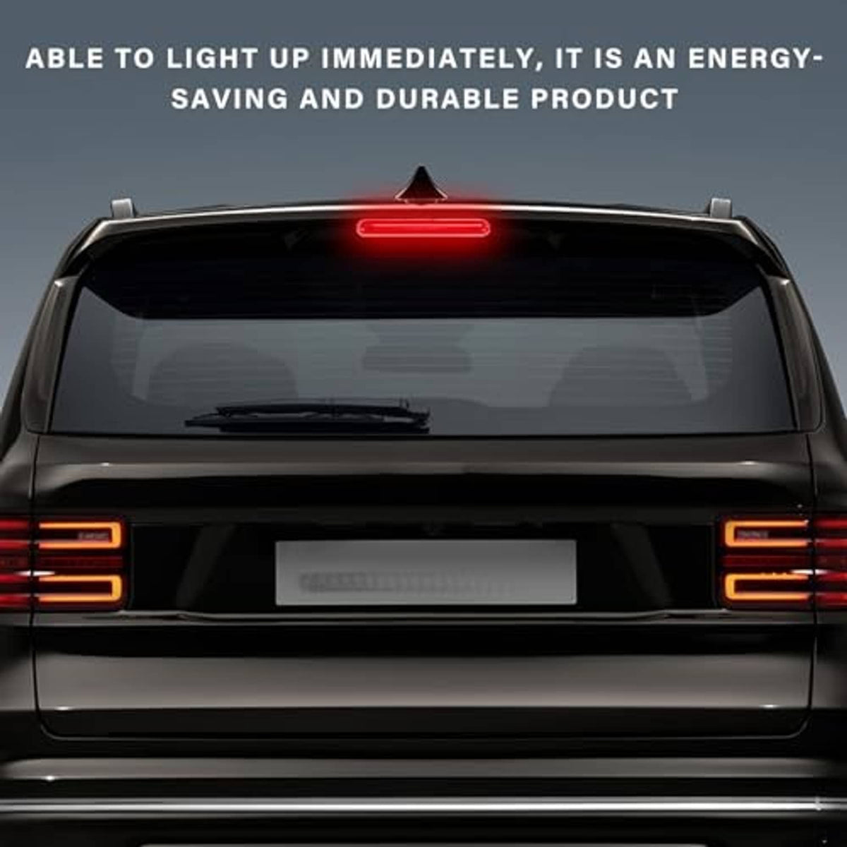 Installed red third brake light on a car rear hatch, centered and illuminated