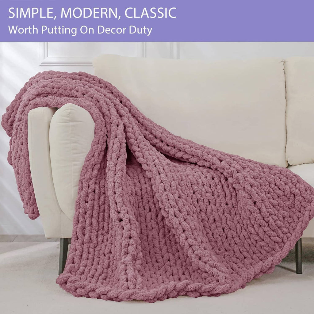 Chunky knit throw blanket, burnt rose, draped over sofa arm, plush thick weave
