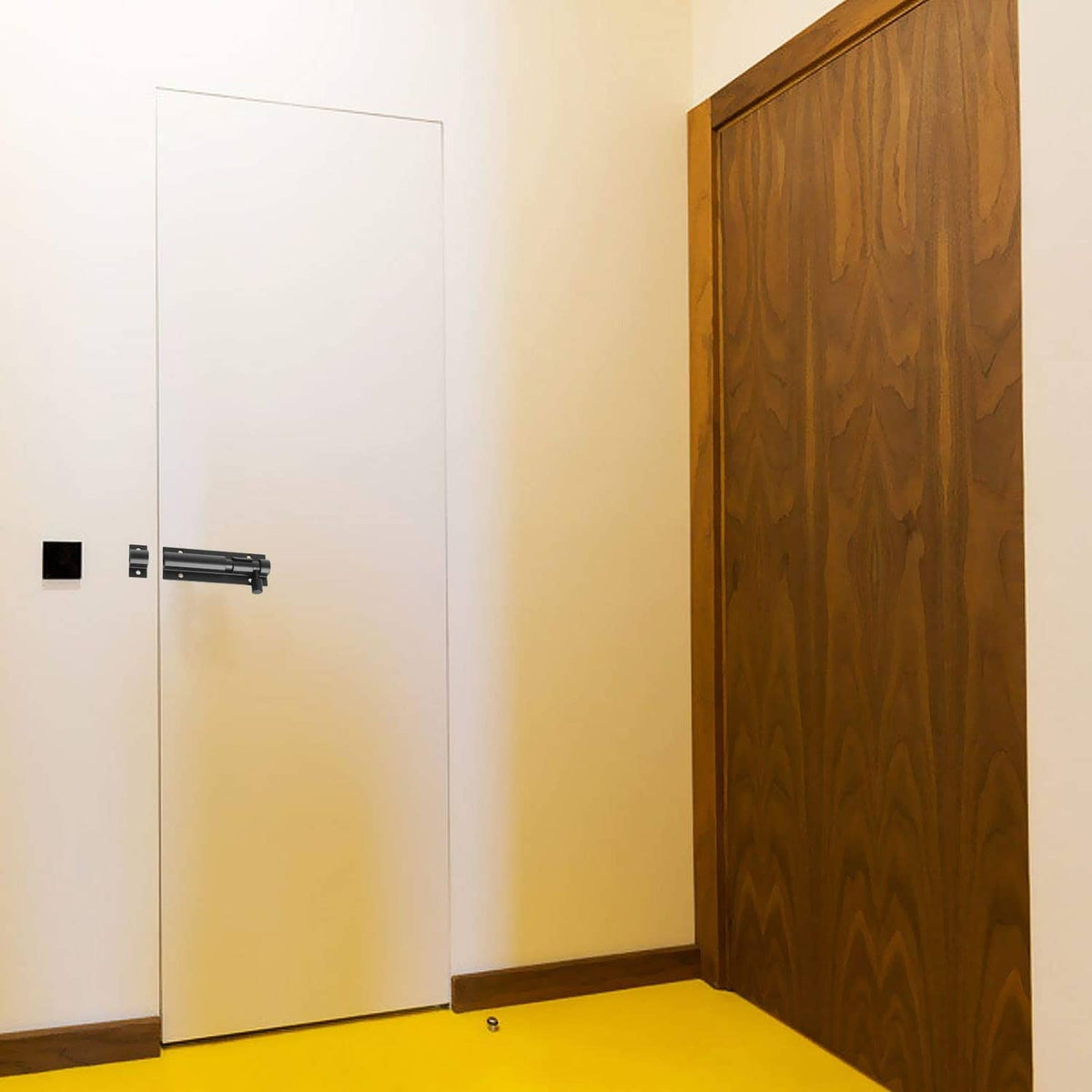 Black slide barrel bolt latch on a door, mounted with base plates and screws