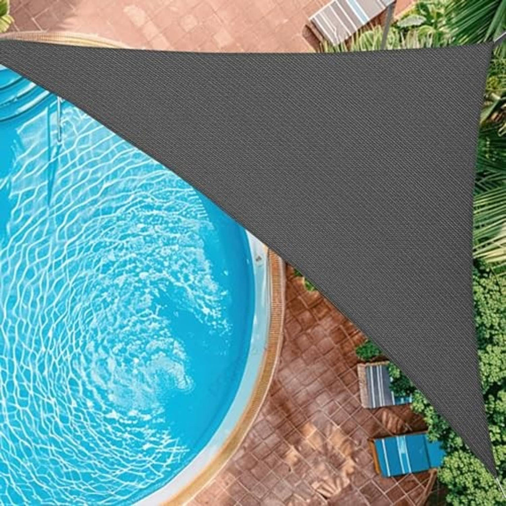 Dark gray curved shade sail over pool and patio walkway