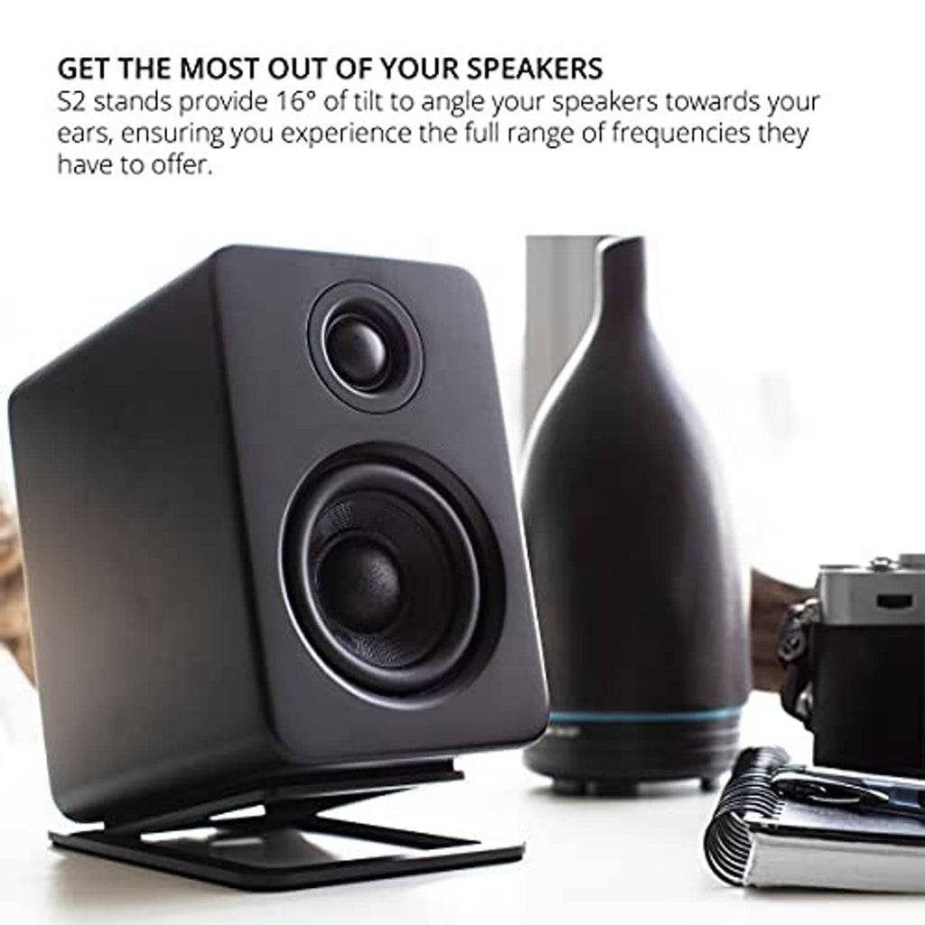 Black tilted speaker stand under a compact desktop speaker for angled listening