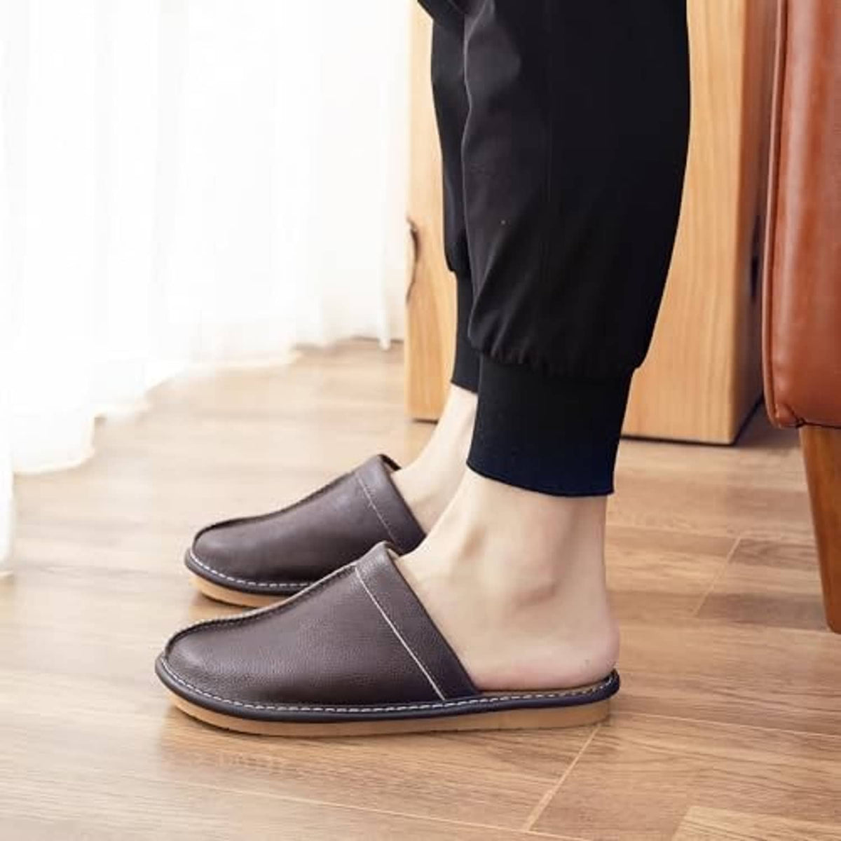 Dark brown leather slip-on slippers with strap opening and stitched rubber sole