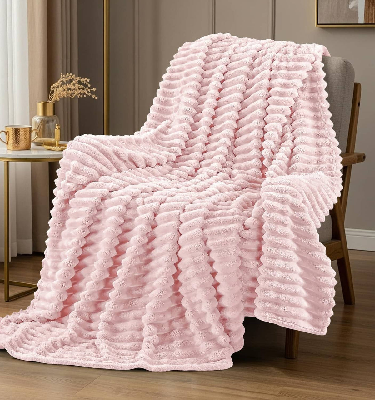 Pink striped fleece blanket draped over a chair, fully spread