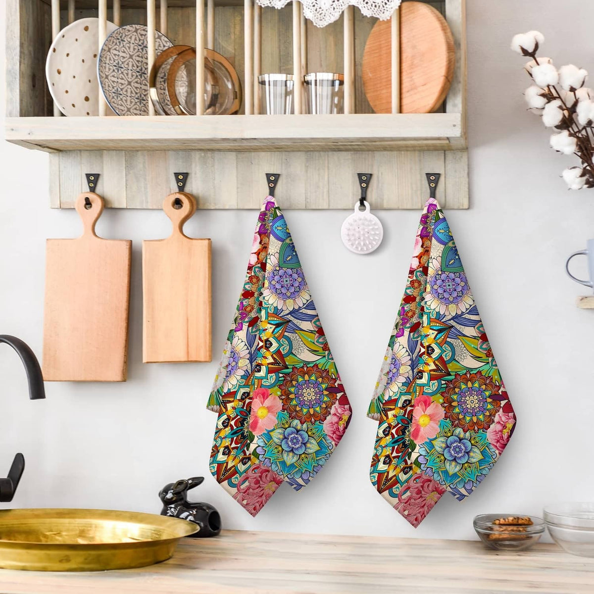 Boho floral kitchen towel pair hanging on hooks, colorful flower print
