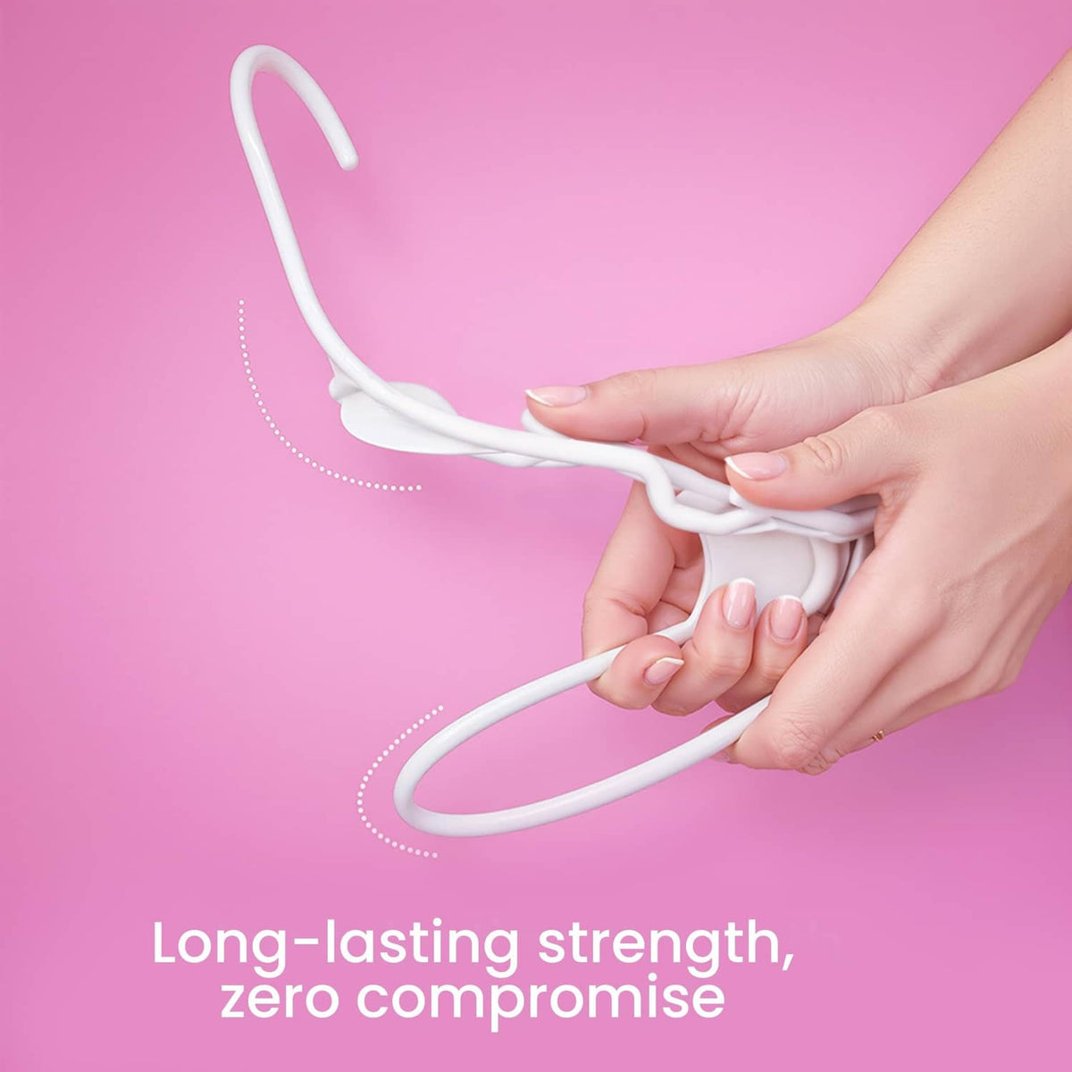 White plastic clothes hanger bent by hands to show flexible strength