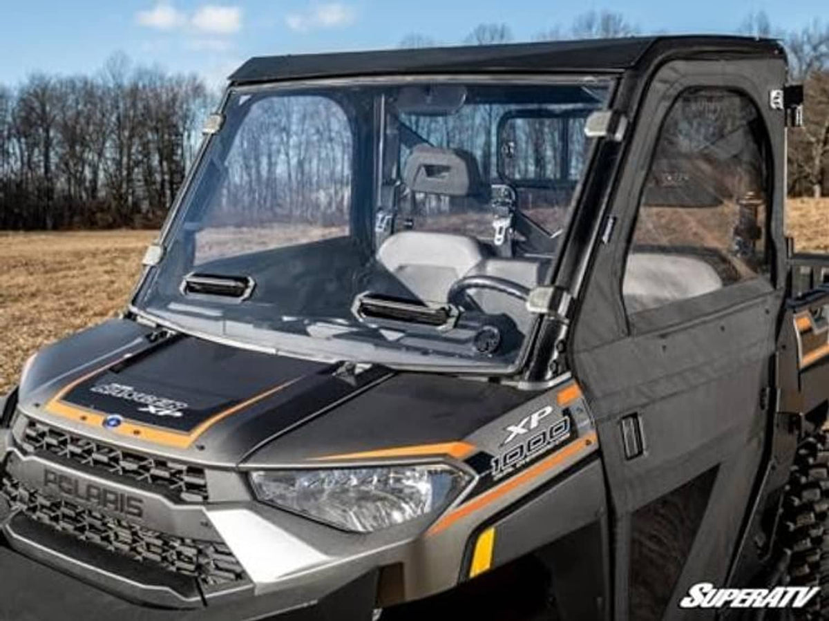 Angled view of preinstalled vented full windshield with black frame on side-by-side