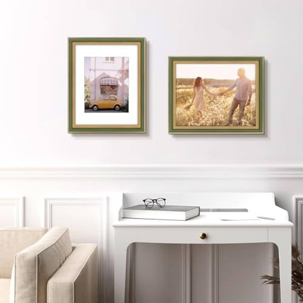 Two ornate green and gold picture frames on a wall, each holding a small photo print.