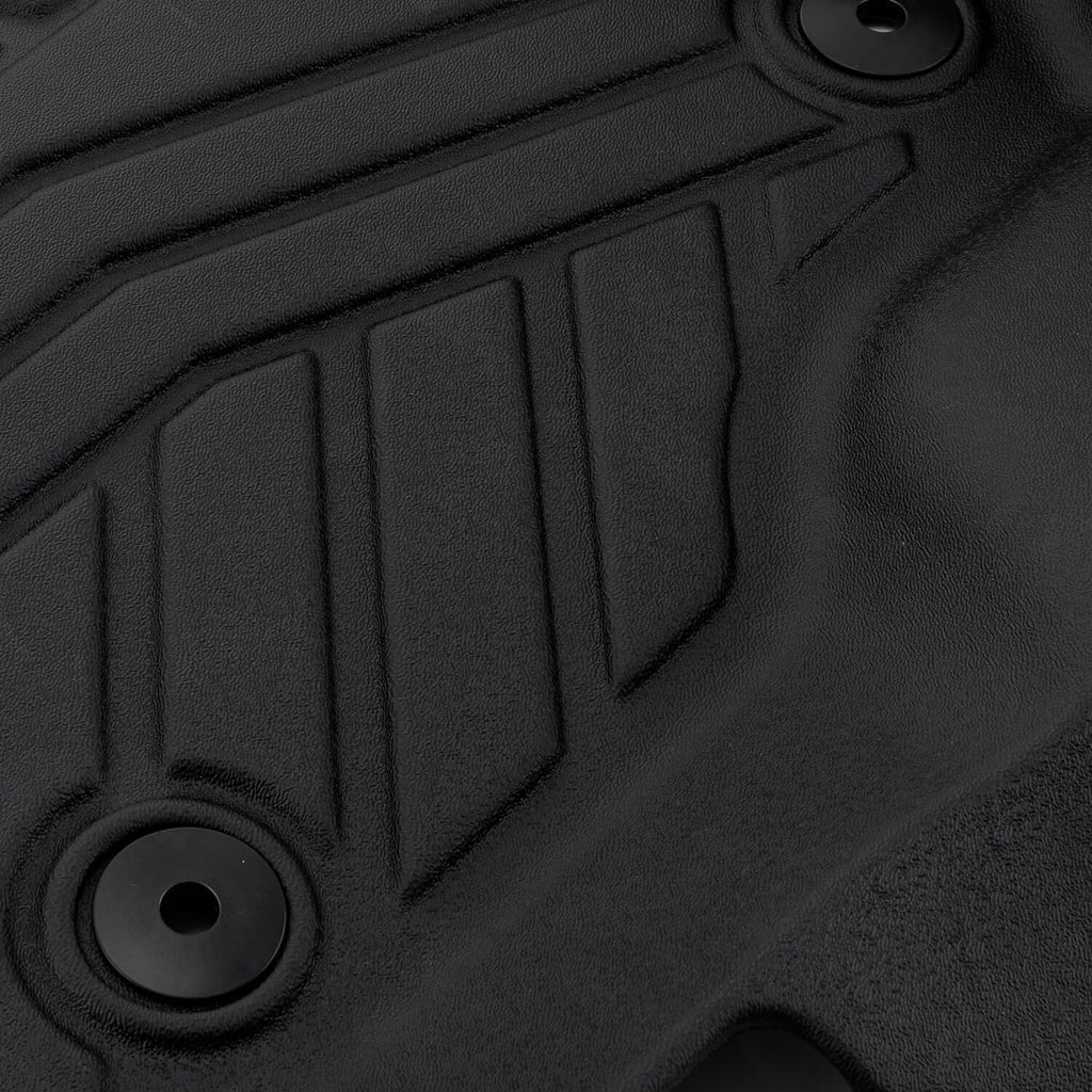 Black TPE floor mat detail with circular anchor hole and embossed grip pattern
