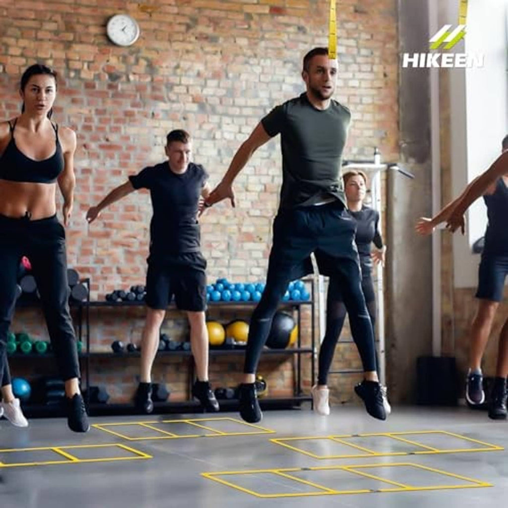 Yellow agility ladder used by athletes for footwork training with multiple participants