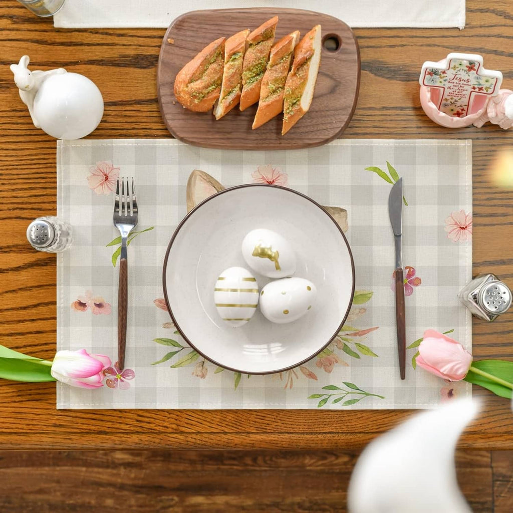 Rectangular beige plaid bunny-ear floral placemat laid on a table.