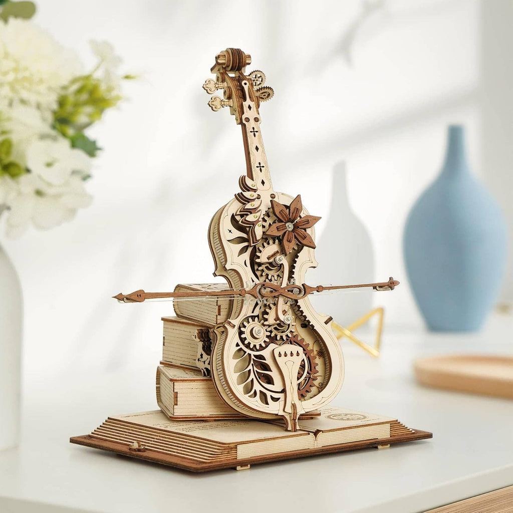 Wooden 3D mechanical cello model with bow and carved gears on a base